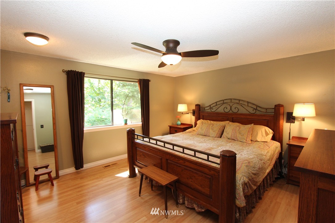 320 170th Place Southwest Bothell, WA 98012 - Photo 10 of 25 a bedroom with a bed a table and chair