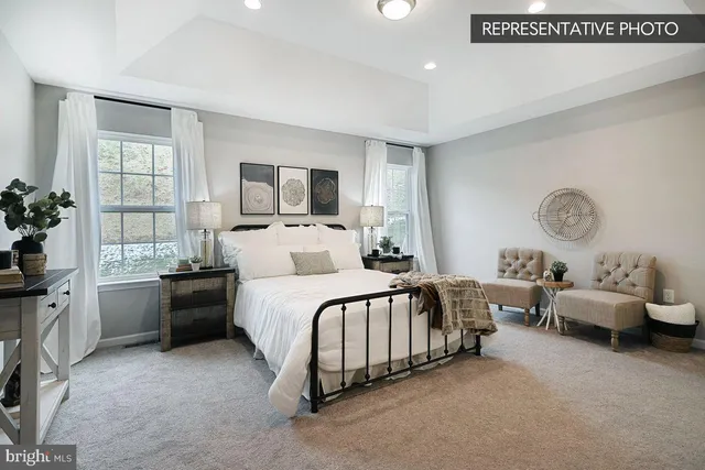 a spacious bedroom with a bed and a large window