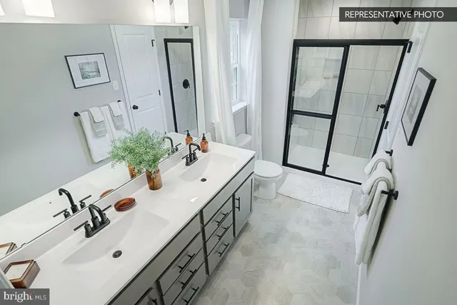 a bathroom with double vanity sink and a mirror