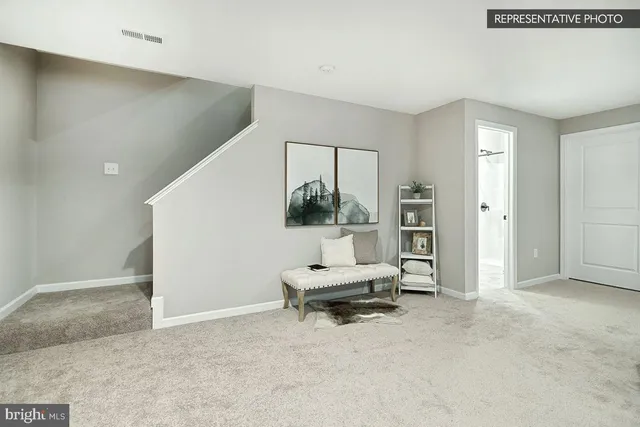 an entryway and livingroom with furniture