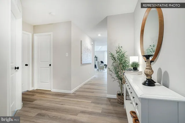 a view of a hallway with workspace and entryway