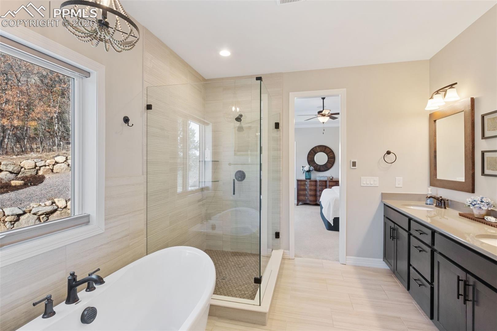 5318 Rocking Tree Grove Colorado Springs, CO 80906 - Photo 20 of 49 The primary bathroom offers a massive glass-enclosed shower and 60 inch free standing tub