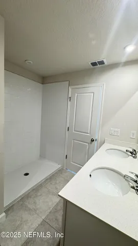 a bathroom with a sink and shower