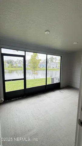 a view of an empty room with a large window