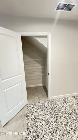 a view of an empty room with a bench