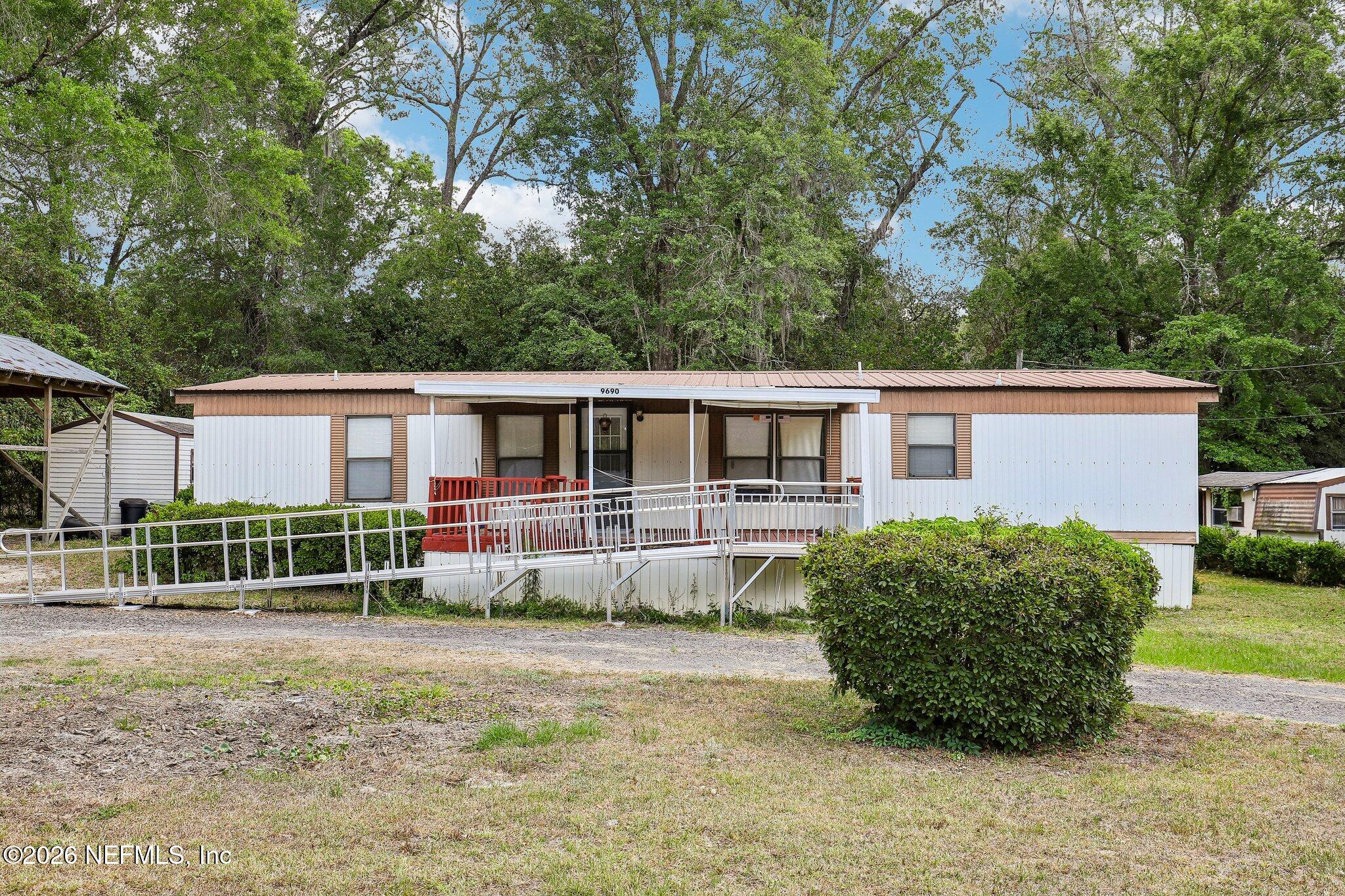 9690 Black Jack Road Macclenny, FL 32063 - Photo 1 of 34 a front view of a house with garden
