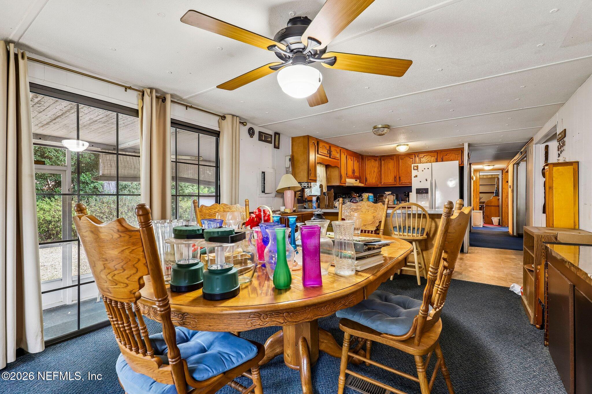 9690 Black Jack Road Macclenny, FL 32063 - Photo 11 of 34 a view of a dining room with furniture window and wooden floor