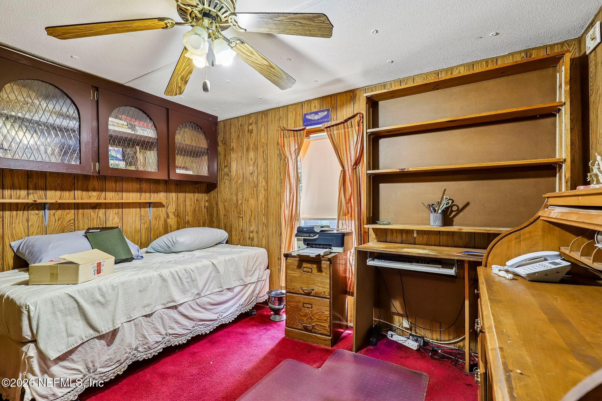 9690 Black Jack Road Macclenny, FL 32063 - Photo 15 of 34 a bedroom with a bed and a chandelier