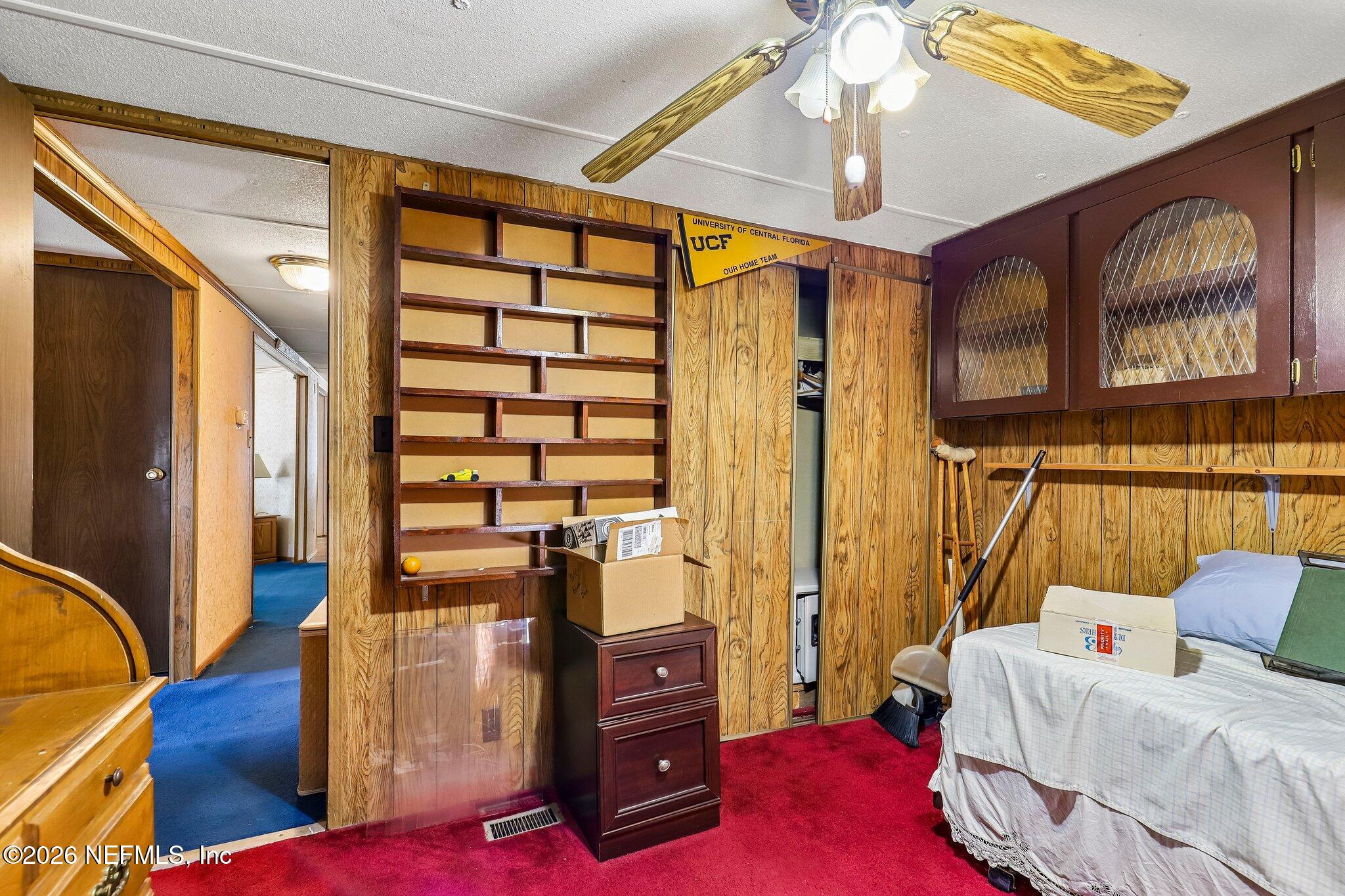 9690 Black Jack Road Macclenny, FL 32063 - Photo 16 of 34 a bedroom with a bed and wooden floor