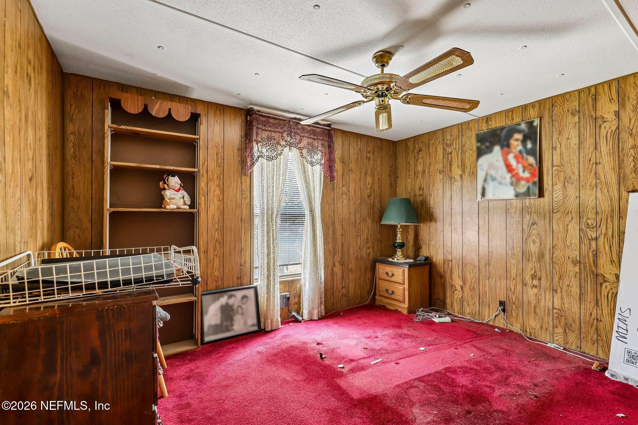 9690 Black Jack Road Macclenny, FL 32063 - Photo 17 of 34 a bedroom with a bed and a chandelier