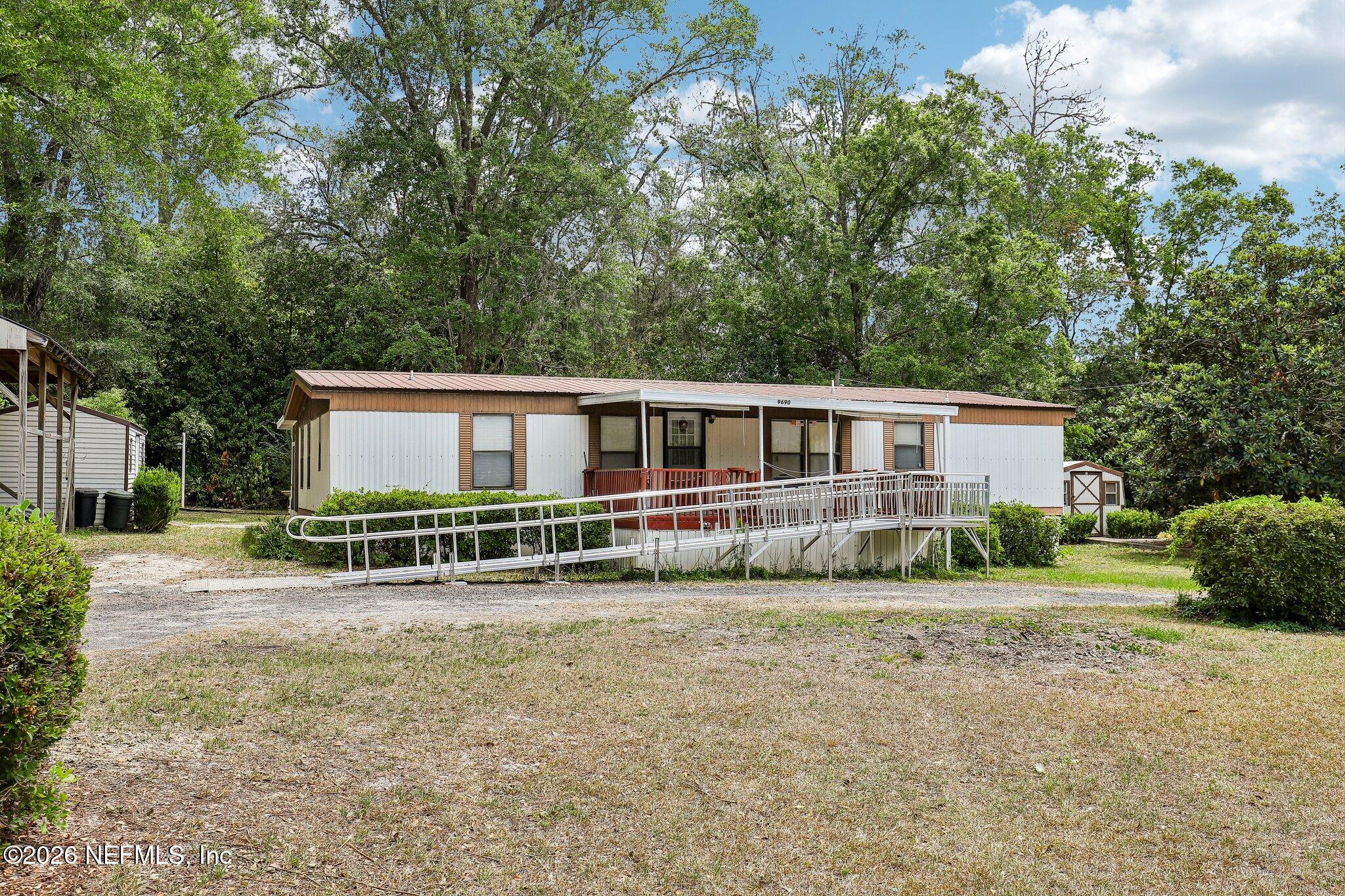 9690 Black Jack Road Macclenny, FL 32063 - Photo 2 of 34 a view of a house with a yard