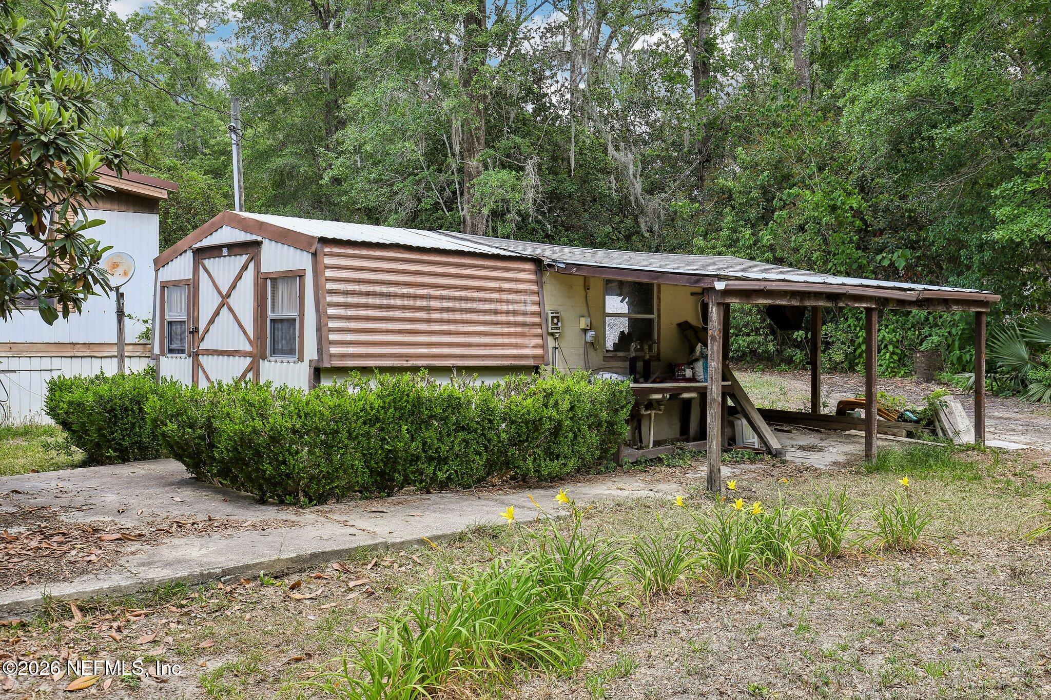 9690 Black Jack Road Macclenny, FL 32063 - Photo 27 of 34 a view of a house with backyard and sitting area