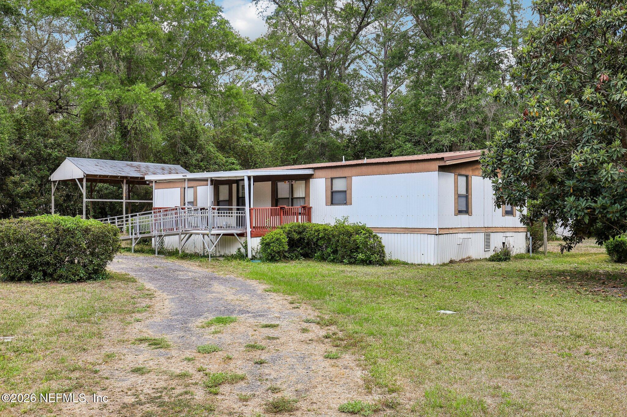 9690 Black Jack Road Macclenny, FL 32063 - Photo 5 of 34 a view of a house with backyard and trees