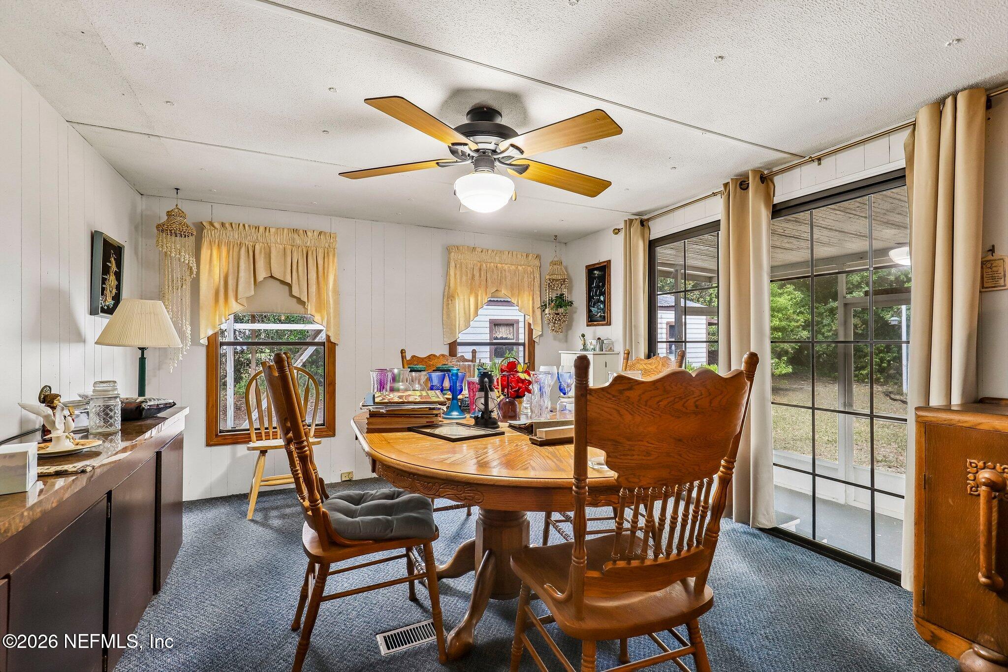 9690 Black Jack Road Macclenny, FL 32063 - Photo 10 of 34 a dining room with furniture a chandelier and wooden floor