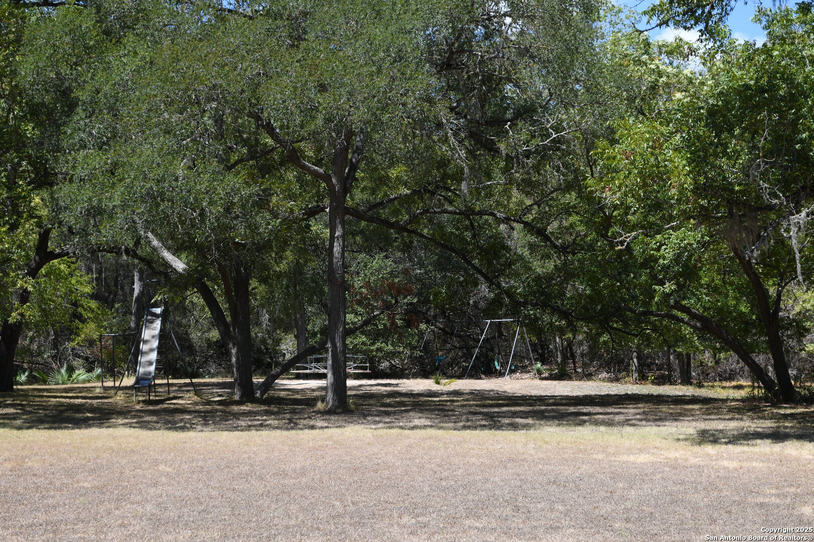 121 Agarita Drive Spring Branch, TX 78070 - Photo 15 of 23 a view of a house with a trees