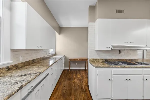 a kitchen with sink stove and cabinets