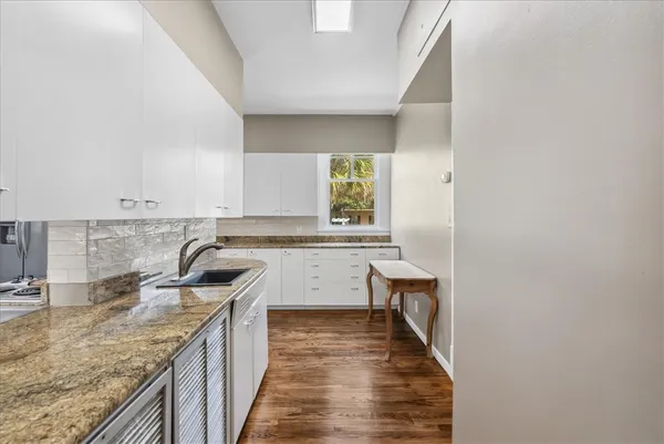 a kitchen with a sink stove and cabinets