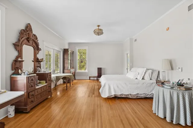 a bedroom with furniture and a wooden floor