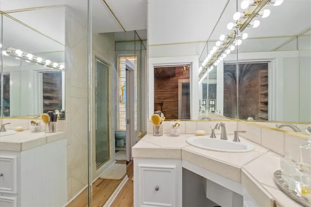 a bathroom with a sink double vanity and a mirror