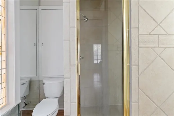 a white toilet sitting next to a bathroom sink