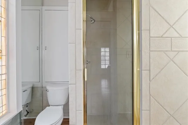 a white toilet sitting next to a bathroom sink