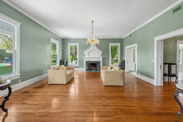 a living room with fireplace furniture and a wooden floor