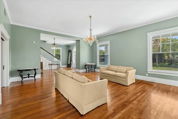 a living room with furniture and a chandelier