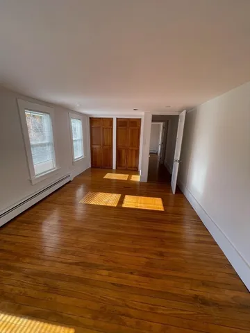 a view of a living room with furniture and wooden floor
