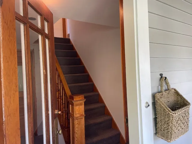 a view of entryway and gallery with wooden floor
