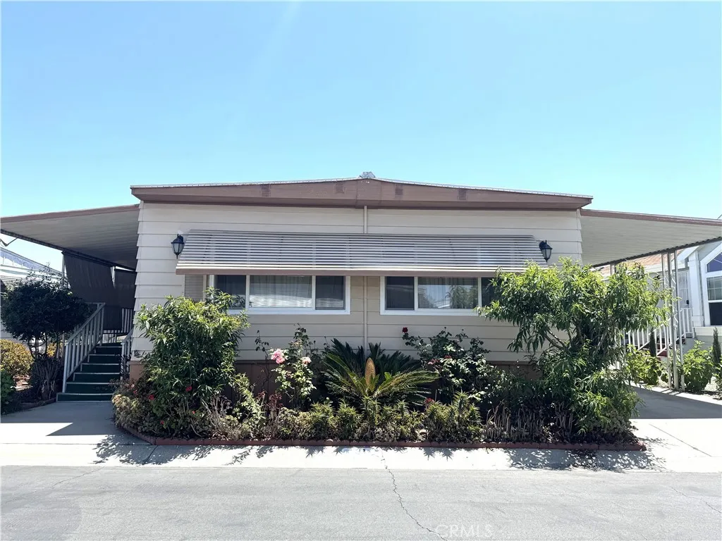 11250 Beach Stanton Ca, Unit 31 Stanton, CA 90680 - Photo 1 of 15 a house view with a garden space