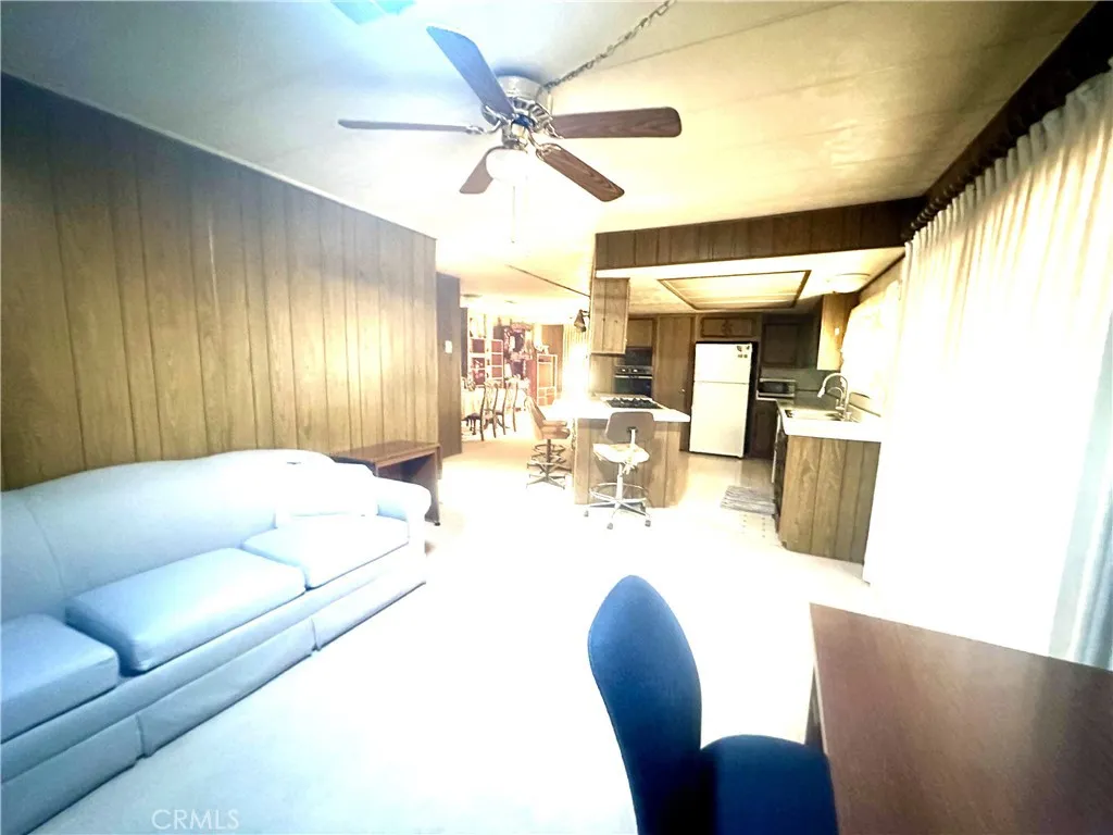 11250 Beach Stanton Ca, Unit 31 Stanton, CA 90680 - Photo 14 of 15 a living room with furniture and a large window