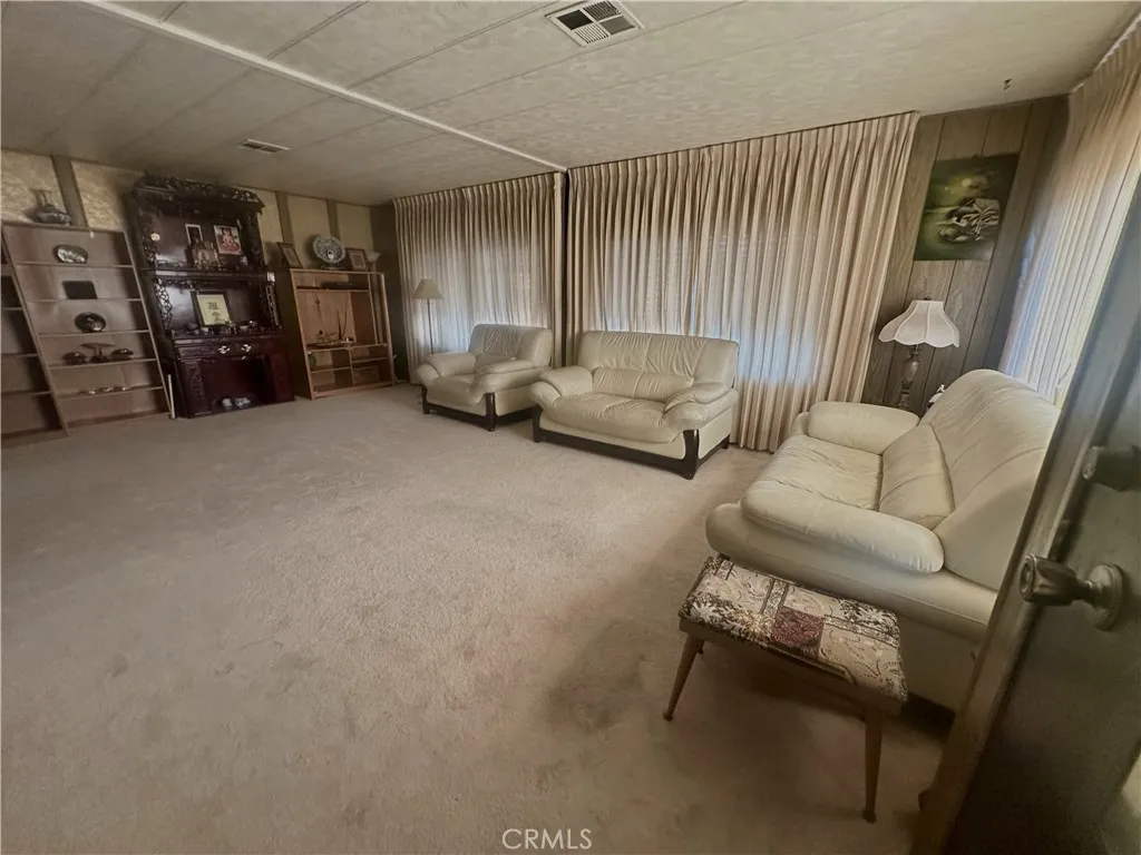 11250 Beach Stanton Ca, Unit 31 Stanton, CA 90680 - Photo 7 of 15 a living room with furniture and a flat screen tv