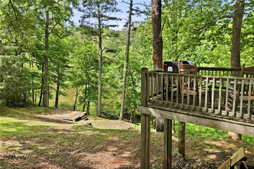 612 Beaver Ridge Road Jasper, GA 30143 - Photo 33 of 38 a view of a deck with a floor to ceiling window and wooden fence
