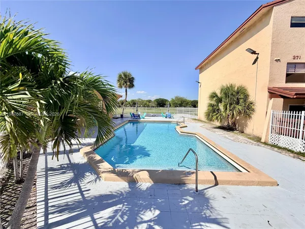 a view of swimming pool with a lounge chairs