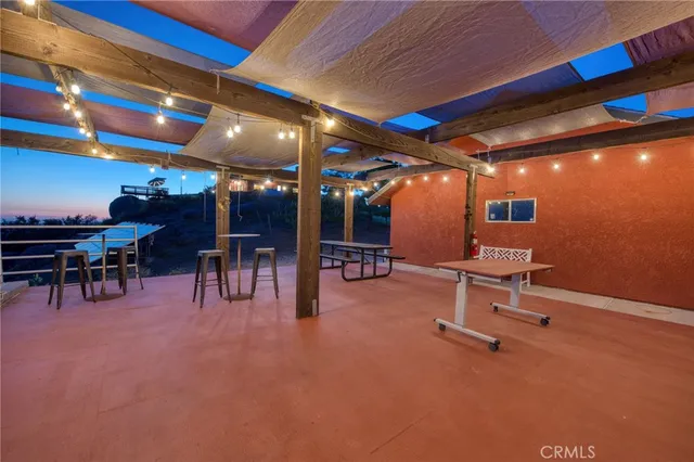 a view of a house with backyard and deck