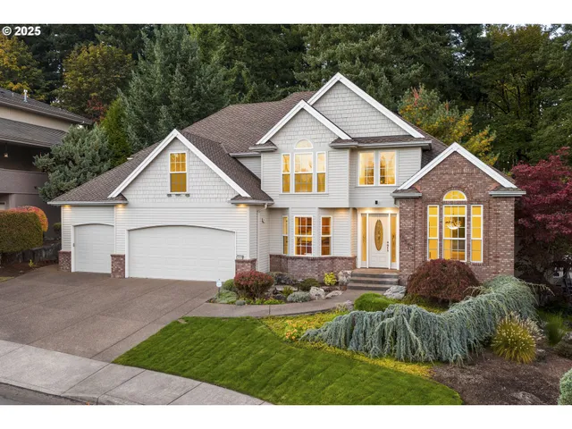 a front view of a house with a yard and garage