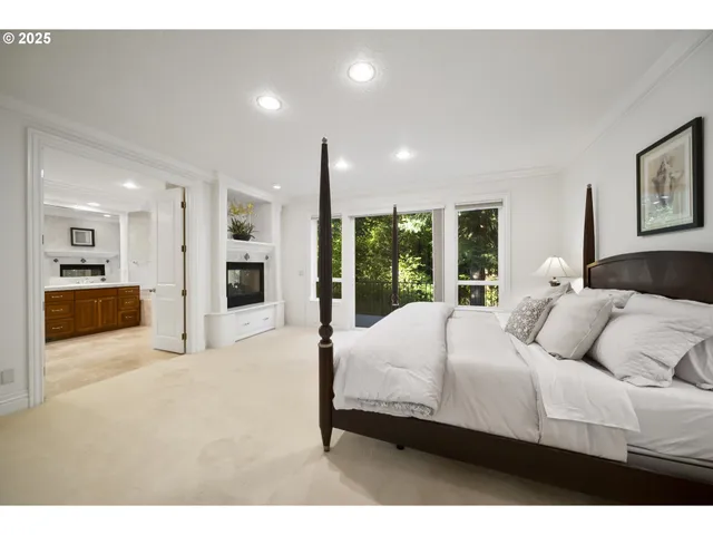 a bedroom with a large bed and a view of kitchen