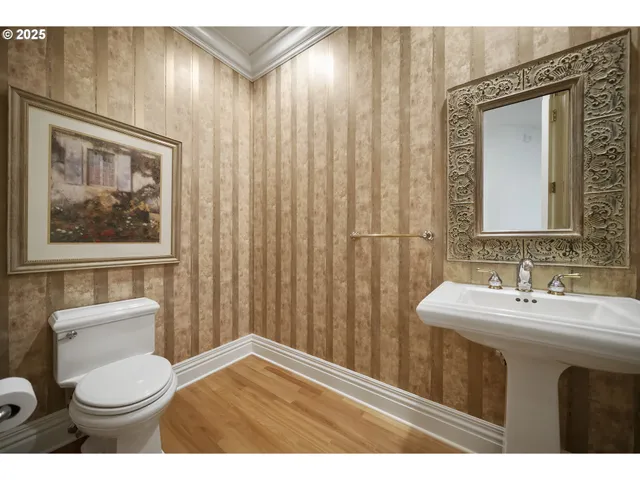 a bathroom with a toilet a sink and a mirror