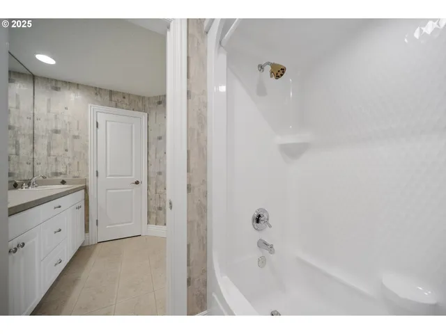 a kitchen with cabinets and a refrigerator