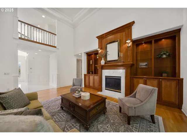 a living room with furniture a fireplace and a large window