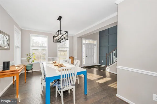 a kitchen with a table chairs and wooden floor