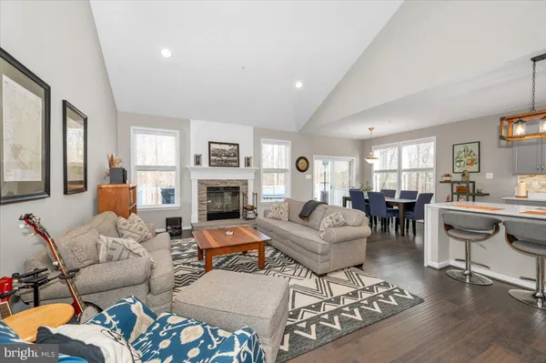 a living room with fireplace furniture and a table