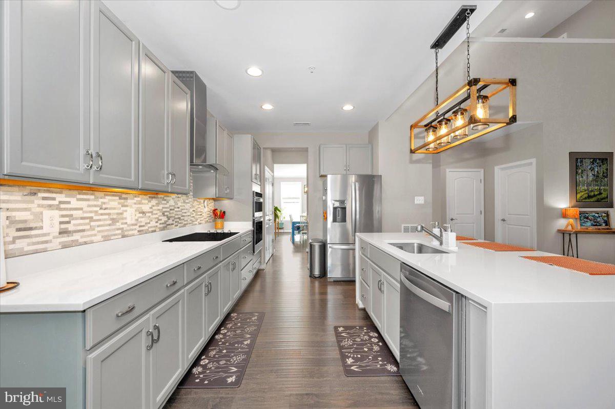 7796 Old Receiver Road Frederick, MD 21702 - Photo 23 of 65 a large kitchen with stainless steel appliances lots of counter space and wooden floor