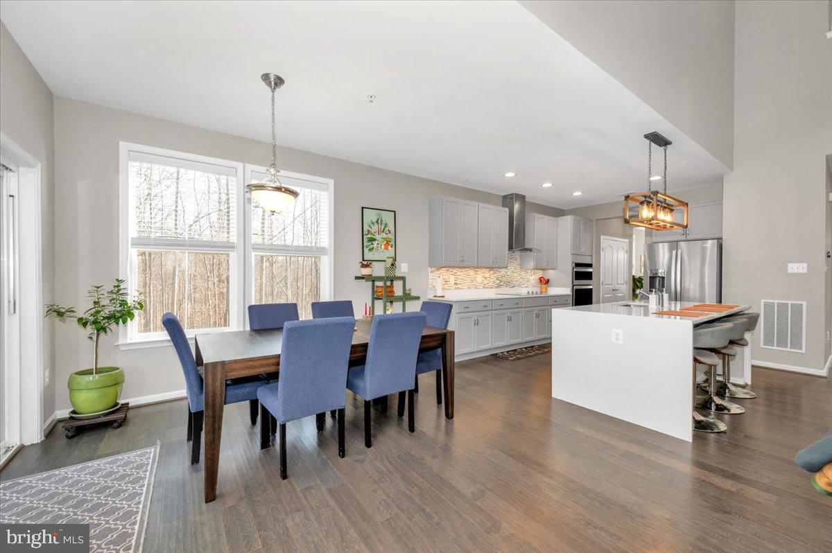 7796 Old Receiver Road Frederick, MD 21702 - Photo 25 of 65 a view of a dining room and livingroom with furniture wooden floor a chandelier