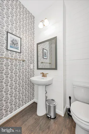 a bathroom with a tub a sink and a large mirror