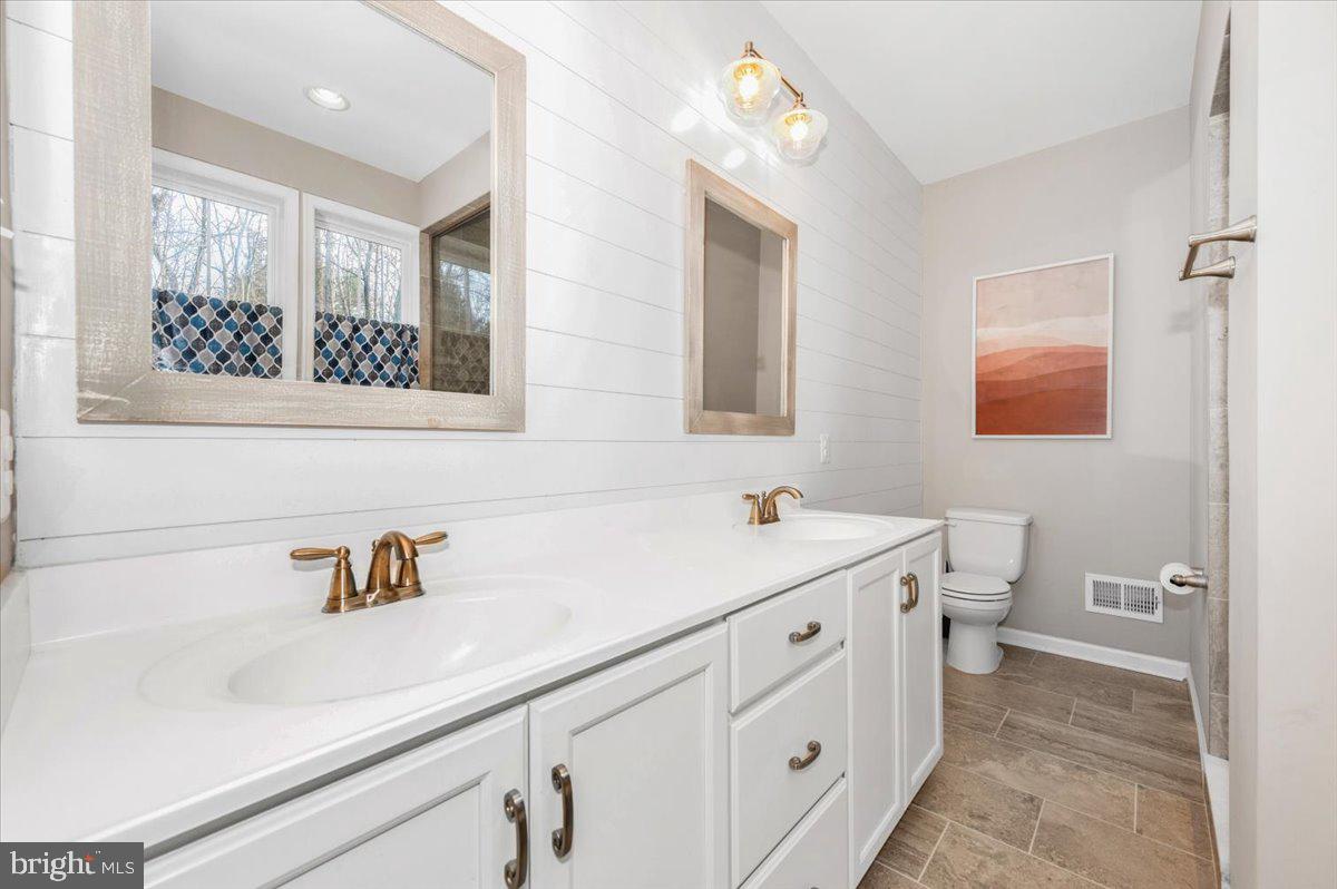 7796 Old Receiver Road Frederick, MD 21702 - Photo 29 of 65 a bathroom with a sink a toilet and mirror