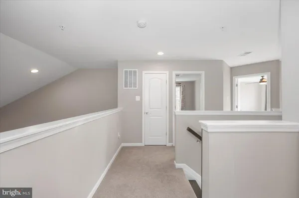 a view of a livingroom with wooden floor and stairs
