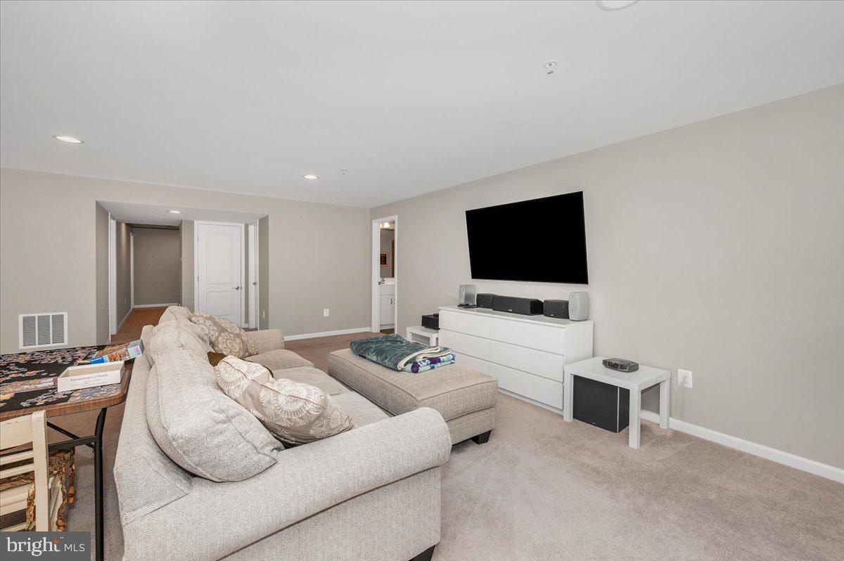 7796 Old Receiver Road Frederick, MD 21702 - Photo 48 of 65 a living room with furniture and a flat screen tv