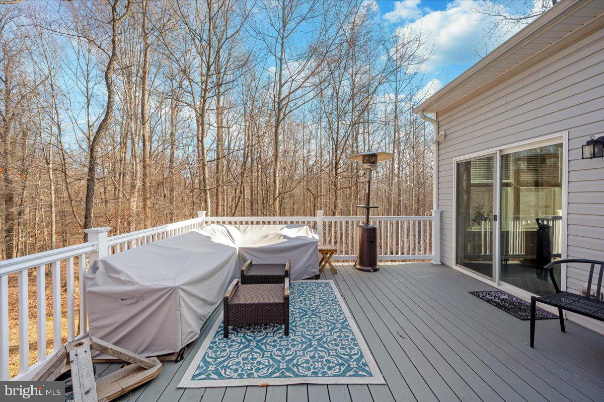 7796 Old Receiver Road Frederick, MD 21702 - Photo 55 of 65 a roof deck with table and chairs and wooden floor