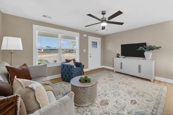 a living room with furniture and a large window